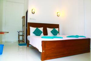 a bedroom with a large bed with blue towels on it at A&B RESORT NEGOMBO in Negombo