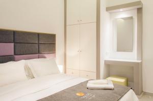 מיטה או מיטות בחדר ב-Talos Luxury Suites