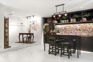 a bar in a room with a table and stools at Nappark Hostel @Khao San in Bangkok