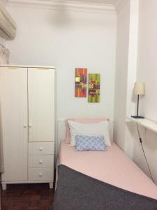 a small bedroom with a bed and a cabinet at Suria Kipark Single Bedroom Apartment in Kuala Lumpur