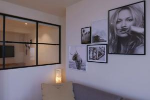 a living room with pictures on the wall at Appartement met Zeezicht in Ostend