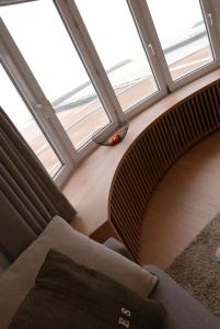 a living room with a couch and a large window at Appartement met Zeezicht in Ostend
