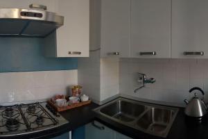 a kitchen counter with a sink and a stove at Vittadinisette in Pavia