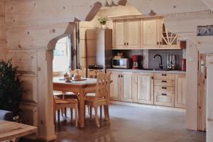a kitchen with a table and chairs in a room at BIAŁY PUCH in Zakopane