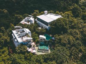 an aerial view of a large house in the forest at Gaia Hotel & Reserve- Adults Only in Manuel Antonio