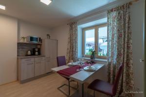 ein Esszimmer mit einem Tisch und einem Fenster in der Unterkunft Apartment Gehrenspitze in Reutte