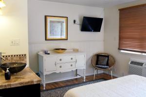 1 dormitorio con vestidor blanco y lavamanos en The Crest Motel, en Sterling