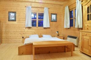 ein Schlafzimmer mit einem Bett in einem Blockhaus in der Unterkunft Ferienhaus Wagner in Bad Ischl