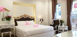 ダラットにあるCarita Hotelのベッドルーム1室(ピンクの弓が付いたベッド1台付) +37枚の写真