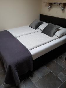 Una cama en una habitación con dos almohadas encima. en Mooi zo 2, en De Koog