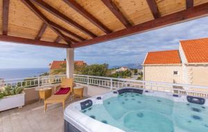 a hot tub on the balcony of a house at Apartment Una in Cavtat