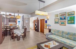 a living room with a couch and a table at Apartment Una in Cavtat