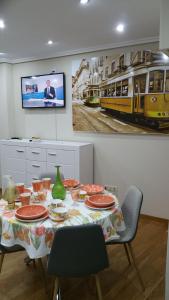 a dining room with a table and a tv on a wall at Apartamento Centro Porriño in Porriño