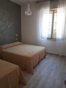 a bedroom with two beds and a window at Villa Donati in Cesenatico