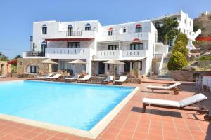 a hotel with a swimming pool in front of a building at Paradisia Villas in Naxos Chora