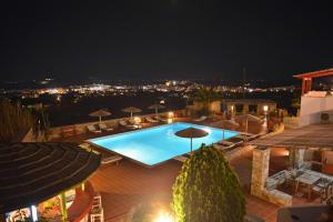 a view of a swimming pool at night at Paradisia Villas in Naxos Chora