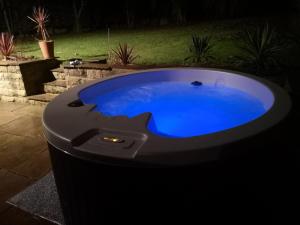 a large hot tub in a yard at night at Laburnum Lodge room in Leeds