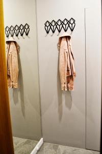 a wardrobe with a coat hanging on a wall at Studio 4 Piętro in Sopot