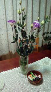 a vase filled with purple flowers on a table at Apartman Nikolic in Bor