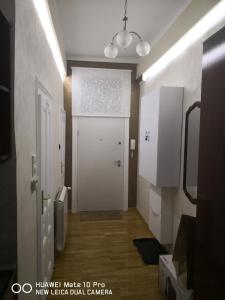 a room with a white door and a hallway with a door at Knez Mihailova Apartman in Belgrade