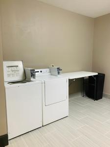a kitchen with a table and a refrigerator at Countryside Suites Lincoln I-80 in Lincoln