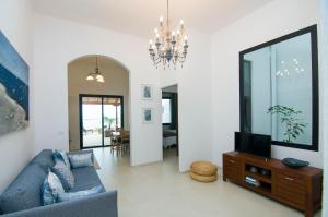 a living room with a blue couch and a tv at Residencial LaMar in Santa Cruz de la Palma