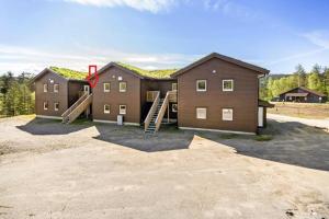 a house with a roof that has a staircase at Bjørndalsvatnet in Hornnes