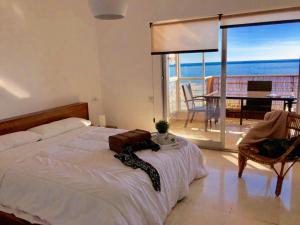 a bedroom with a bed and a view of the ocean at Stunning Sea View in Alicante