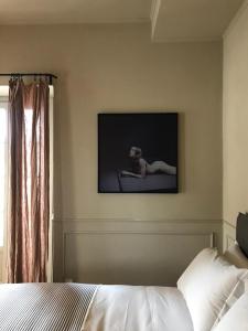 a bedroom with a bed and a tv on the wall at Suites Menaggio in Menaggio