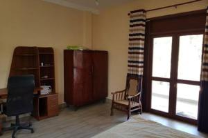 a bedroom with a desk and a chair and a window at Rohan's Residence in Kandana