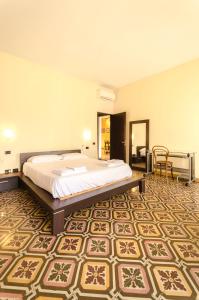 a bedroom with a bed and a table and chairs at Piazza Maggiore Suite in Bologna