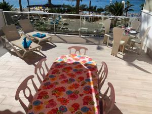 a table with a colorful table cloth on a balcony at Los Cristianos Best Beach View in Arona