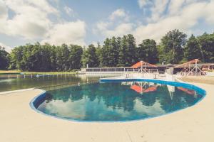 a large pool of water with a roller coaster at Landhuisjes Bij De Wouterbron in Opglabbeek