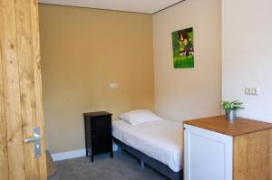 a small bedroom with a bed and a door at Central-Day Inn in Enschede