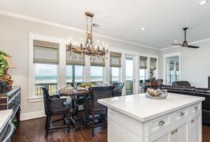 a kitchen and dining room with a chandelier at Beachfront Bliss in Galveston