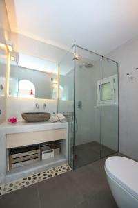 a bathroom with a sink and a glass shower at Villa Casa Dodo Mare in Elia Beach +34 photos