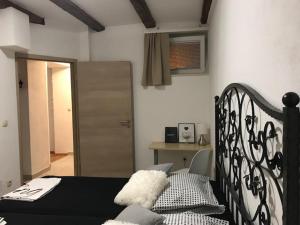 a bedroom with a black bed and a chair at Apartment Bruno in Šibenik