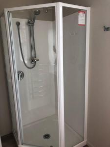 a shower with a glass door in a bathroom at Park-Inn Lodge in Dorie