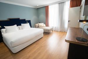 A bed or beds in a room at Soho Boutique Congreso