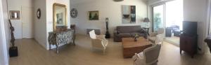 uma sala de estar com um sofá e uma mesa em Vue exceptionnelle sur les Tours ! Charme et tranquillité em La Rochelle