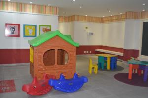 a play room with a dog house and a table at Sun Paradise - JTR in Maceió