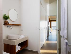 a bathroom with a sink and a mirror at Reflections Shaws Bay - Holiday Park in Ballina