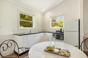 a kitchen with a table and a white refrigerator at Clouds Montville in Montville