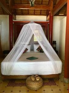 Lova arba lovos apgyvendinimo įstaigoje Le Domaine De Tam Hai Resort