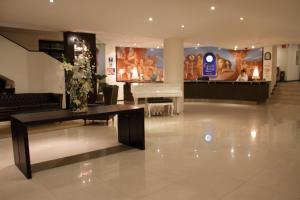 a lobby with a piano and a vase of flowers at Hotel Clara Luna in Xalapa