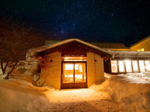 a building in the snow at night at Shiretoko Village in Shari
