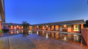 an empty parking lot in front of a building at Moama Central Motel in Echuca