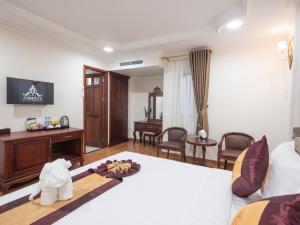 a hotel room with a bed and a desk at Air Star Hotel in Ho Chi Minh City