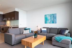 
a living room filled with furniture and a coffee table at The Dolphin Apartments in Apollo Bay
