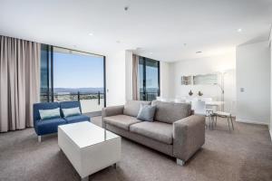 a living room with a couch and a table at The Wave Resort in Gold Coast